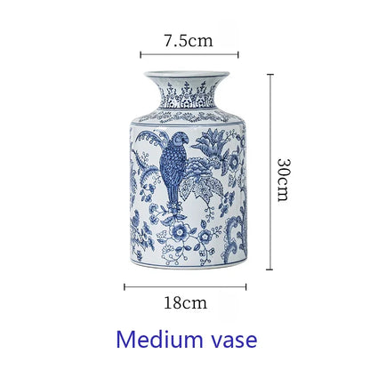 Blue and white vase with floral and parrot design, shown with measurements on a white background.