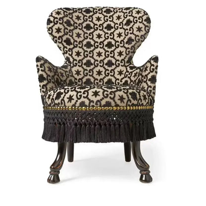 Decorative chair with patterned fabric and wooden legs on a white background