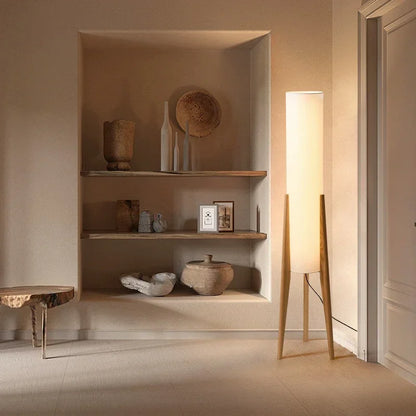 Nestled alcove with shelves displaying decorative items in a softly lit room.