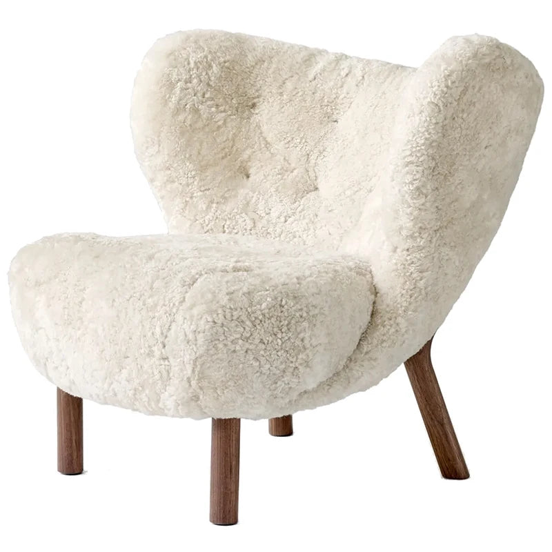 White fluffy armchair with wooden legs on a white background