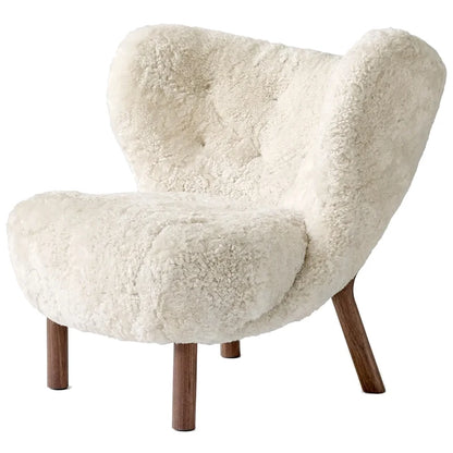 White fluffy armchair with wooden legs on a white background