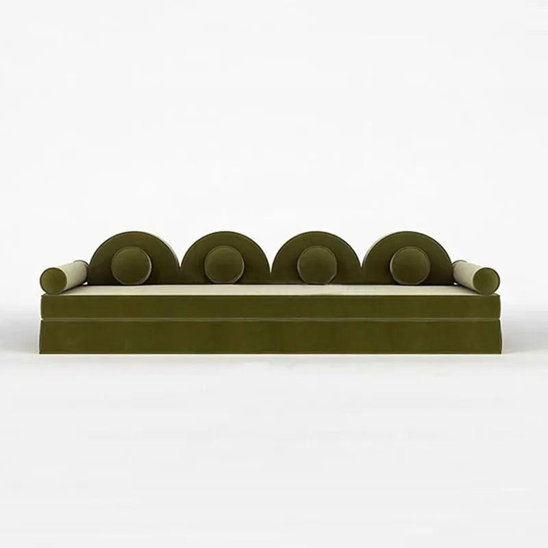 Modern green sofa with circular armrests on a white background