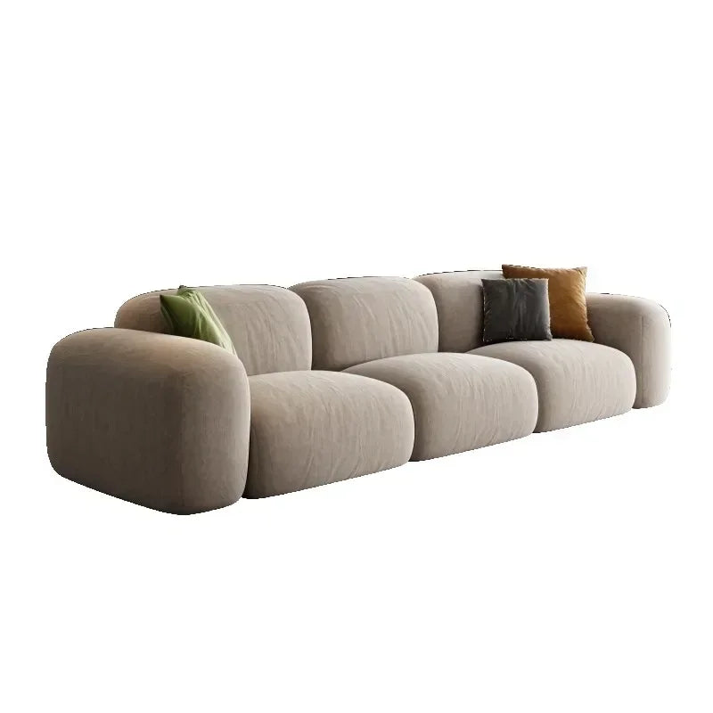 Beige sofa with cushions on a white background