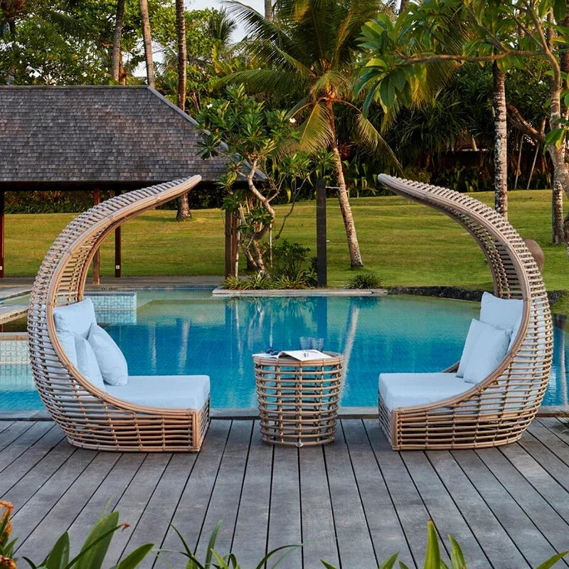 Versatile rattan sun lounger converting from chair to bed.