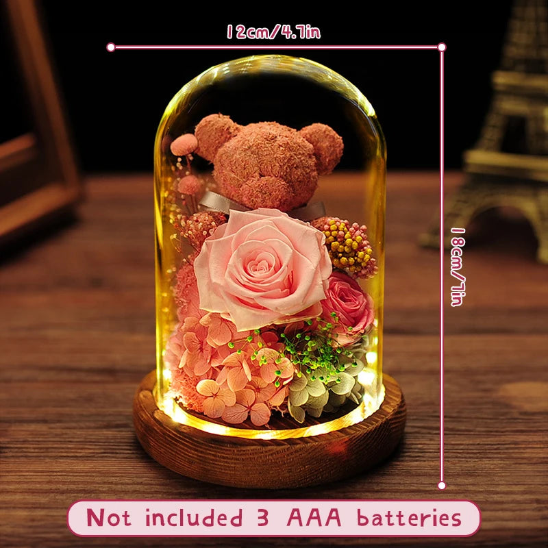 Preserved flower bear displayed on a bedside table.