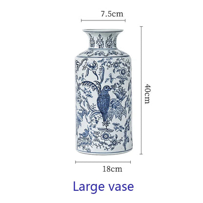Blue and white decorative vase with floral and bird patterns, shown with measurements on a white background.