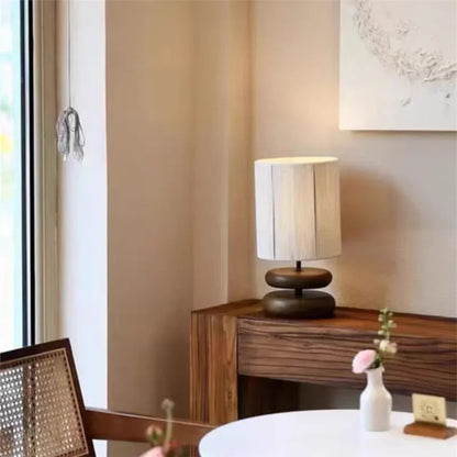 Modern lamp on a wooden side table in a room with a chair and decor.