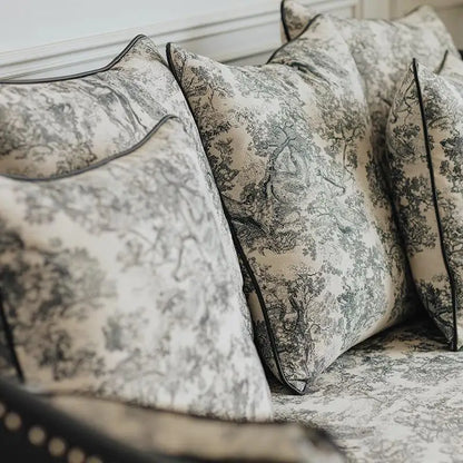 Patterned pillows on a sofa with a neutral background