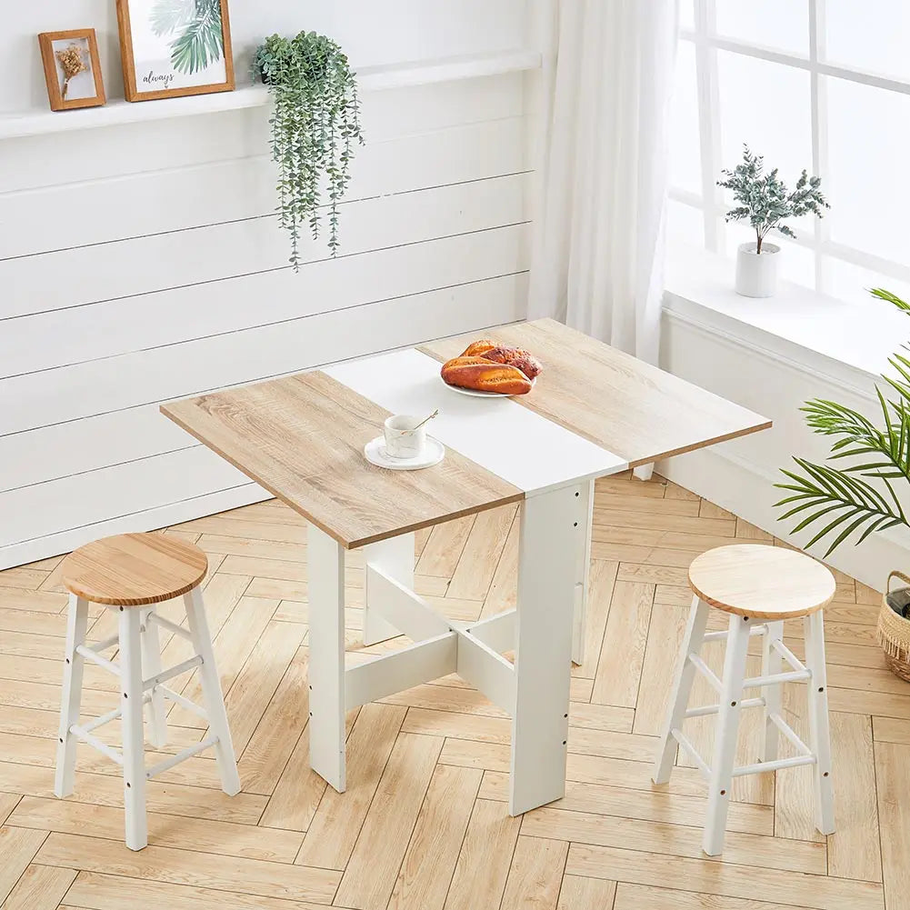 Foldable wooden dining table in white and natural finish.