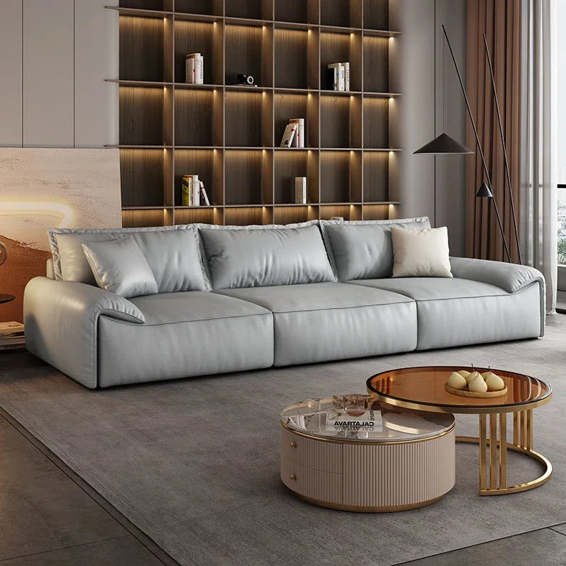 Modern living room with a gray sofa, coffee table, and bookshelf.