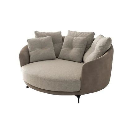 Round beige sofa with cushions on a white background