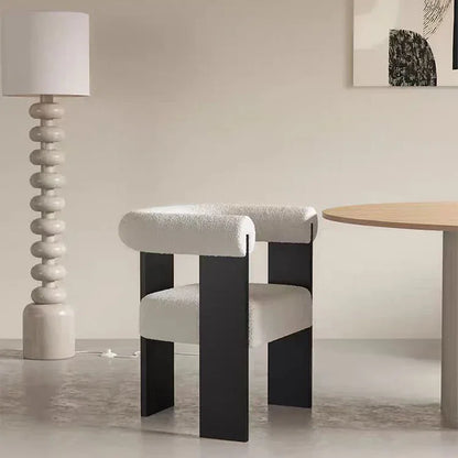 Durable solid wood dining chair with a sturdy frame, upholstered in luxurious lambskin for lasting quality.