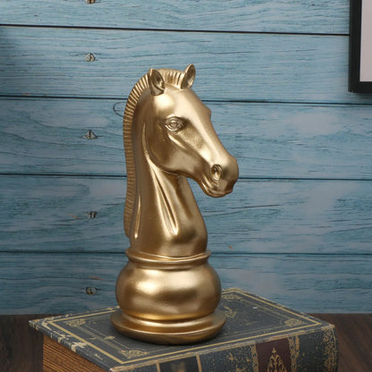 Gold horse head sculpture on a book with a blue wooden background
