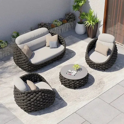 Luxury Outdoor Rattan Sofa Set on Sunny Patio with Garden Plants