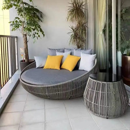 Stylish outdoor garden round bed chair in a landscaped garden.