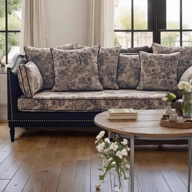 Living room with a floral-patterned sofa and wooden coffee table.