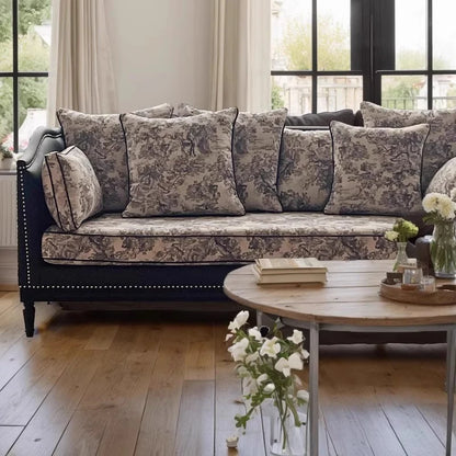 Living room with a floral-patterned sofa and wooden coffee table.