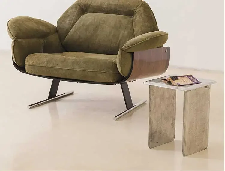 Green armchair with a side table on a white background