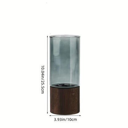 Modern glass vase with wood accents for minimalist living room decor.