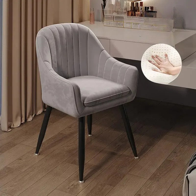 Gray upholstered chair with black legs on a wooden floor, close-up of fabric texture shown.