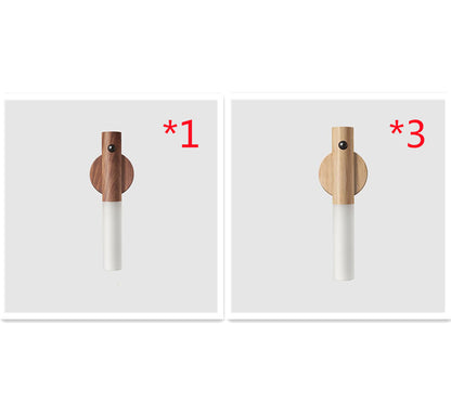 Two wooden pegs with white cylindrical bases on a white background