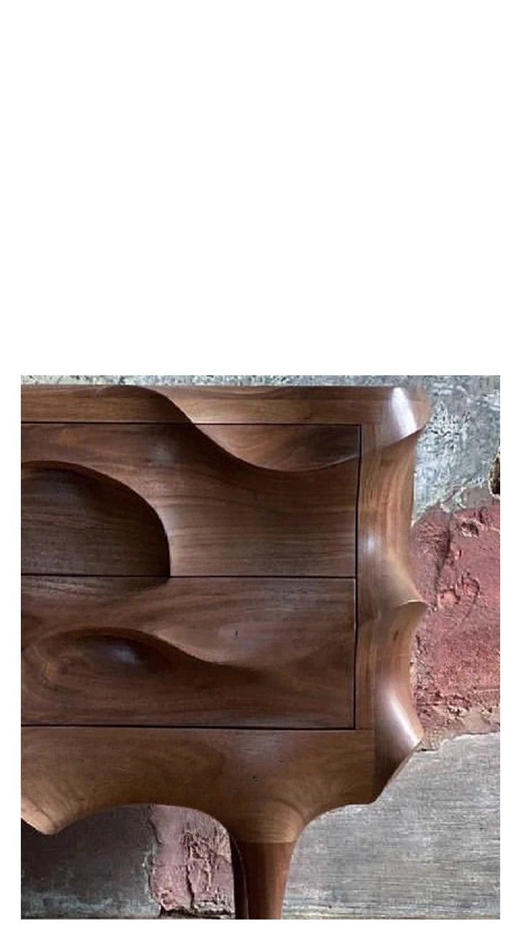 Wooden drawer with wavy design on a textured surface