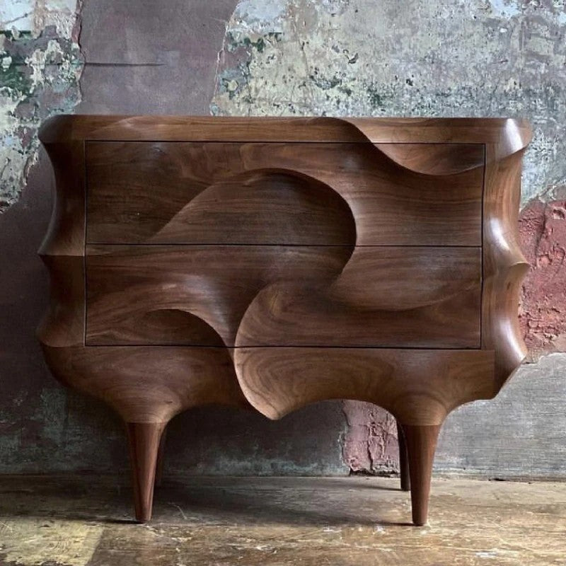 Wooden side table with wavy design against a textured wall.
