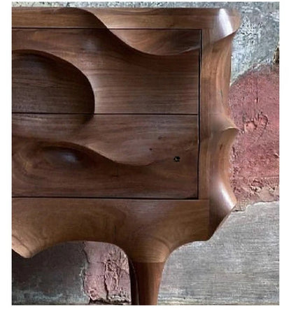 Wooden side table with wavy design on a textured surface