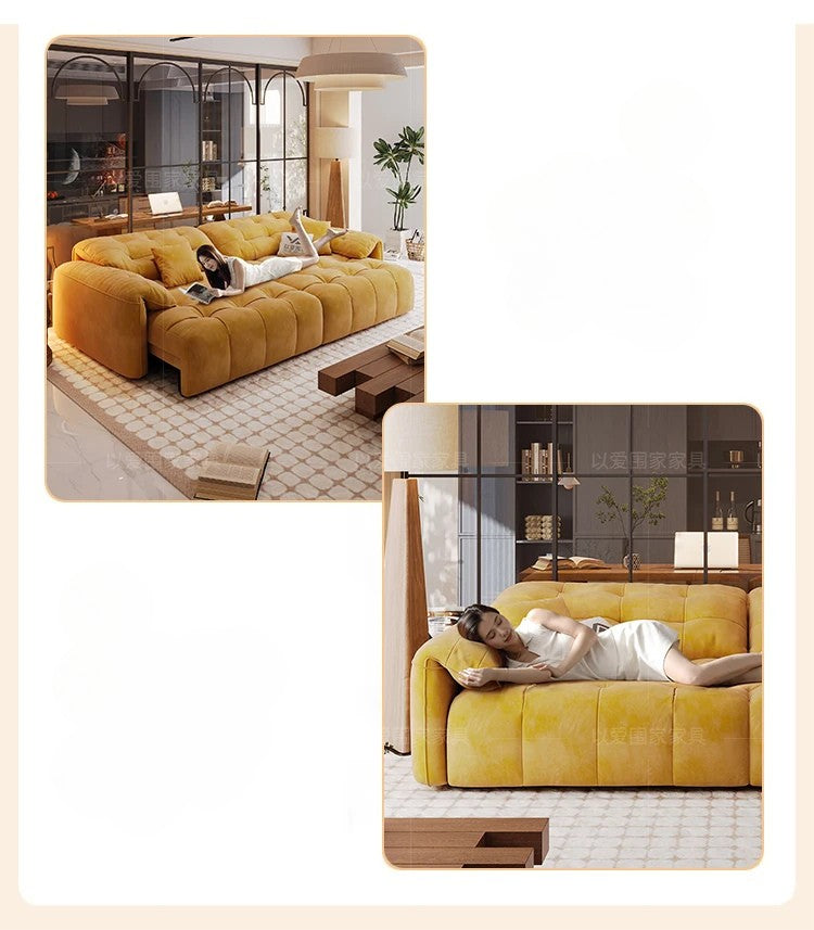 Yellow sofa in a modern living room setting with a woman lying on it.