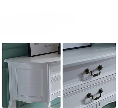 White dresser with black handles on a white background