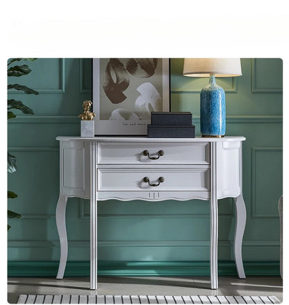 White side table with decorative items against a green wall