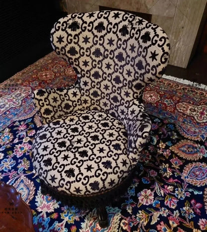 Decorative chair with black and white pattern on a colorful rug