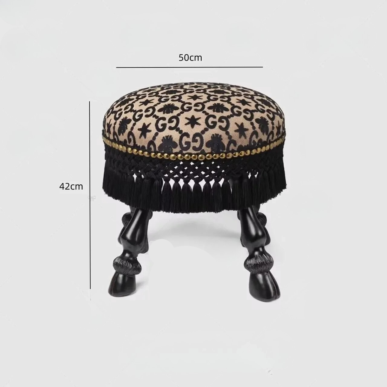 Small round stool with leopard print top and black fringes on a white background