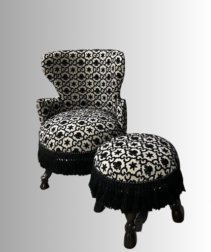 Decorative chair and ottoman with black and white pattern on a gray background