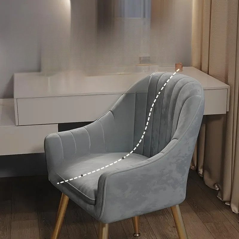 Gray armchair in a room with a desk and curtains