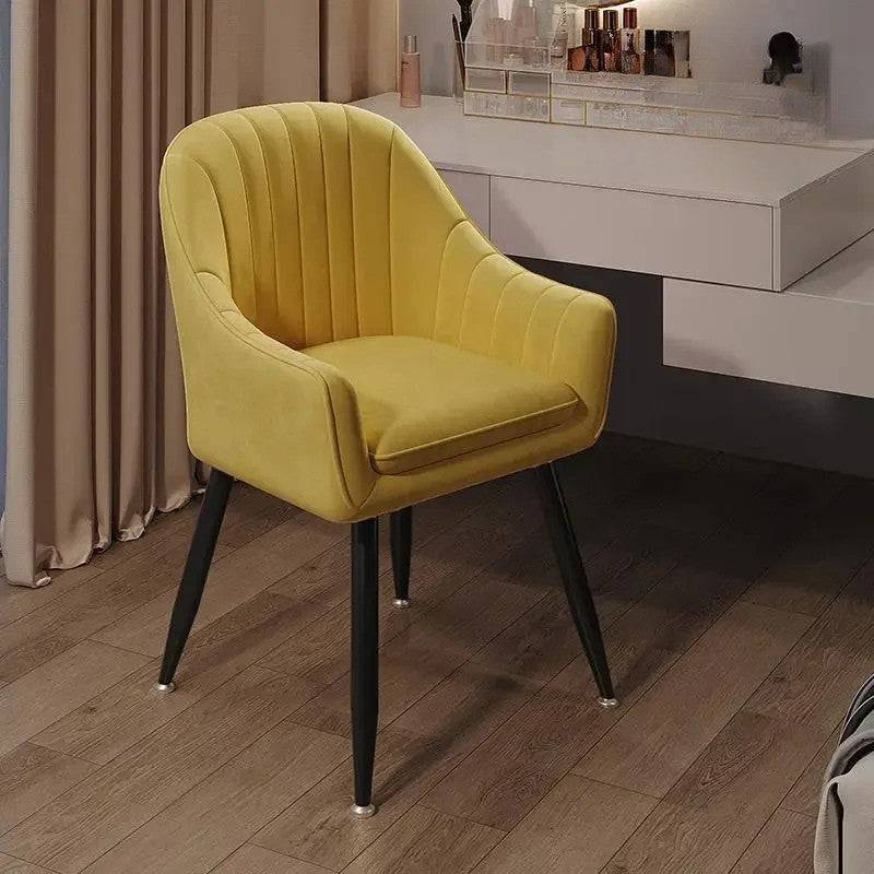 Yellow armchair on a wooden floor with a blurred background