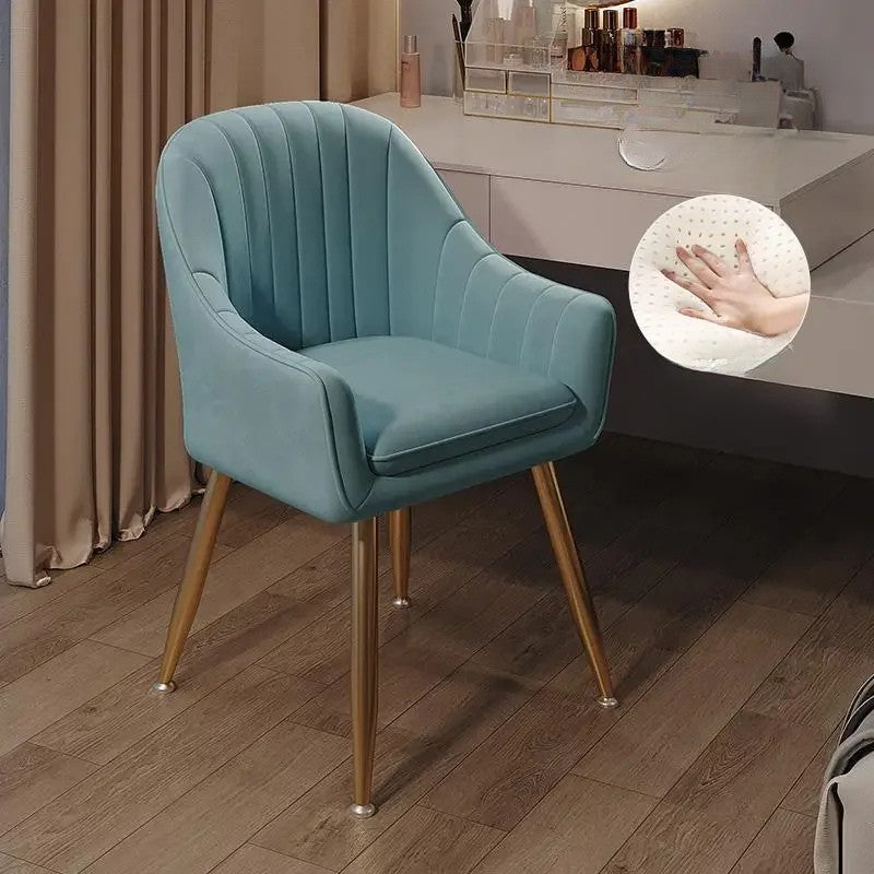 Teal armchair with gold legs on a wooden floor, inset showing hand touch test.